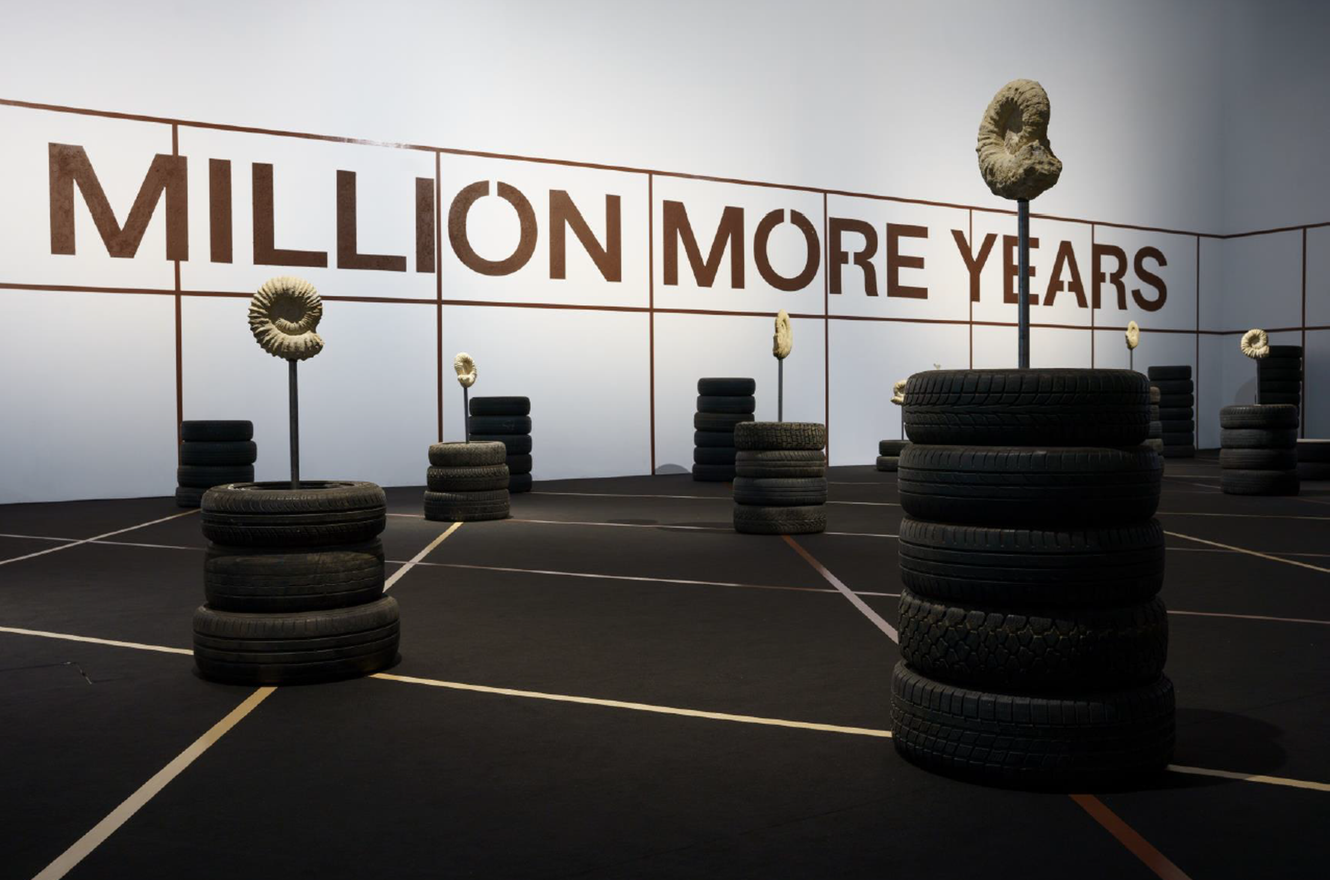 We Demand a Million More Years ( 2022 Jonas Staal Ammonite fossils of approximately 100 million years old, metal rods, hardened oil, defunct car tires, various dimensions